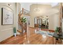 Stunning entryway with curved staircase, hardwood floors, and high ceilings, flowing into the dining area at 5722 S Benton Way, Littleton, CO 80123