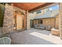 Inviting front porch featuring a stone archway, wood ceiling, and comfortable seating area at 5722 S Benton Way, Littleton, CO 80123