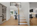 Inviting foyer with wood floors and staircase with a black iron railing at 5698 Green Oaks Dr, Greenwood Village, CO 80121