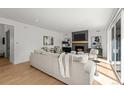 Bright living room with fireplace, mantel, and neutral color scheme at 5698 Green Oaks Dr, Greenwood Village, CO 80121