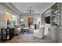 Comfortable living room with large window and built-in shelving at 5698 Green Oaks Dr, Greenwood Village, CO 80121
