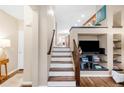 Bright entryway featuring hardwood floors, a staircase with white risers and a custom built-in media center at 2958 N Xenia St, Denver, CO 80238