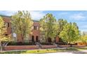 Attractive brick townhomes boast mature trees and well-maintained landscaping at 2958 N Xenia St, Denver, CO 80238