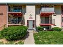 The main entrance of the apartment building, featuring well-maintained landscaping and inviting access at 12156 Melody Dr # 201, Westminster, CO 80234