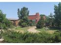 Two-story home with landscaped yard and unique architectural details at 9655 Morrison Rd, Lakewood, CO 80227