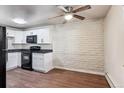 Modern kitchen with white cabinets, granite counters, and black appliances at 875 S Quebec St # 24, Denver, CO 80247