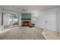 Comfortable living room boasts a fireplace, soft carpet, and access to a balcony at 1074 S Dearborn St # 103, Aurora, CO 80012