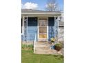 Welcoming front door with security screen and concrete porch steps at 4040 Ames St, Wheat Ridge, CO 80212