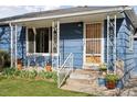 Inviting covered porch with decorative ironwork, providing a pleasant spot to relax at 4040 Ames St, Wheat Ridge, CO 80212