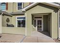 Close up of front entrance to home showing the entrance and a small patio area at 6916 Crestop Pl # F, Parker, CO 80138