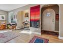 Living room features a unique arched fireplace and beautiful hardwood floors at 1610 Locust St, Denver, CO 80220