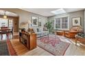Bright and airy living room with a skylight, hardwood floors, and a view into the dining room at 1610 Locust St, Denver, CO 80220