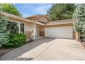 Home exterior with stone accents, a two-car garage, and beautiful curb appeal at 6407 S Heritage W Pl, Centennial, CO 80111