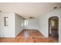 Bright living room with hardwood floors, ceiling fan, and arched entryway, awaiting personalization at 1195 Boston St, Aurora, CO 80010