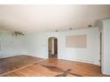 Spacious living room featuring hardwood floors and arched doorway, offering a classic layout at 1195 Boston St, Aurora, CO 80010