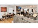 Inviting living room featuring a comfortable gray sofa, a fireplace, and an open layout that flows into the dining area at 2136 S Josephine St, Denver, CO 80210