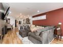 Open-concept living space with a cozy seating area, hardwood floors, and seamless flow to the modern kitchen at 2136 S Josephine St, Denver, CO 80210