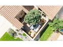 Aerial view of courtyard featuring a large tree, seating area, water feature, and access to indoor living space at 11241 E Cimmarron Dr, Englewood, CO 80111