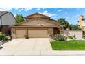 Charming home featuring a stone facade, two-car garage, and beautifully landscaped front yard in a great neighborhood at 11241 E Cimmarron Dr, Englewood, CO 80111