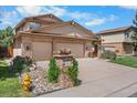 Inviting home featuring a stone facade, two-car garage, and nicely landscaped front yard in a great neighborhood at 11241 E Cimmarron Dr, Englewood, CO 80111