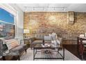 Charming living area featuring exposed brick, contemporary furniture, and lots of natural light at 3321 Navajo St, Denver, CO 80211