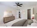 Spacious bedroom with ceiling fan, neutral walls, carpet and light wood dresser, offering a peaceful retreat at 3550 S Harlan St # 177, Denver, CO 80235
