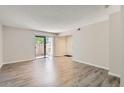 Spacious living room with sliding glass doors leading to a patio and neutral wall paint at 3550 S Harlan St # 177, Denver, CO 80235