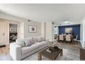 Open-concept living and dining area with modern furnishings and stylish decor at 3550 S Harlan St # 177, Denver, CO 80235