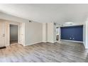 Open concept living room showcasing gray flooring and access to other areas of the house at 3550 S Harlan St # 177, Denver, CO 80235