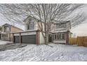 Beautiful home with a three-car garage and brick accents, set in a peaceful neighborhood and mature landscaping at 6550 S Oak Ct, Littleton, CO 80127