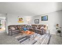 Spacious living room featuring a large comfortable sectional and a modern rug at 770 S Youngfield, Lakewood, CO 80228