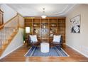 Cozy living room with a beautiful built-in bookcase and hardwood floors at 913 Alkire Ct, Golden, CO 80401
