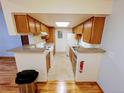 Bright kitchen with granite countertops, white appliances, and a breakfast bar at 8600 E Alameda Ave # 17-203, Denver, CO 80247