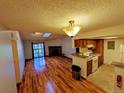 Open living space with wood floors, stone fireplace, and a kitchen with modern appliances at 8600 E Alameda Ave # 17-203, Denver, CO 80247