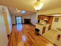 Open living space with wood floors, stone fireplace, and a kitchen with modern appliances at 8600 E Alameda Ave # 17-203, Denver, CO 80247