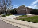 Attractive single Gathering home with an attached garage, long driveway and a well-maintained lawn at 1229 Berganot Trl, Castle Pines, CO 80108