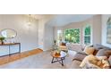 Bright living room featuring neutral colors, plush carpet, and large windows overlooking the front yard at 1229 Berganot Trl, Castle Pines, CO 80108