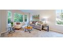 Bright living room featuring neutral colors, plush carpet, and large windows overlooking the backyard at 1229 Berganot Trl, Castle Pines, CO 80108