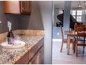 Butler's pantry with granite countertops and view into a formal living area at 6588 S Sheridan Loop, Littleton, CO 80123