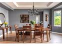 Dining room featuring hardwood floors, modern chandelier, and large windows for natural light at 6588 S Sheridan Loop, Littleton, CO 80123