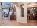 Inviting entryway with wood floors, iron-rail staircase, and views into the living and dining areas at 6588 S Sheridan Loop, Littleton, CO 80123