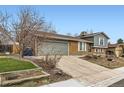 Charming home with attached garage, long driveway, green lawn, and well-maintained landscaping at 7074 Yates St, Westminster, CO 80030