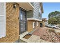 Inviting front entryway with brick facade, modern door, manicured landscaping, and a 'Welcome Home' doormat at 7074 Yates St, Westminster, CO 80030
