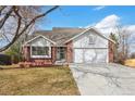 Charming brick home with a two-car garage and well-maintained lawn offers classic curb appeal at 2043 E Nichols Dr, Centennial, CO 80122