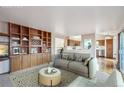 Cozy living room with built-in shelving, comfortable seating, and view into the kitchen at 2043 E Nichols Dr, Centennial, CO 80122