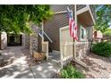 Charming entryway showcasing stone accents and a welcoming path, complemented by an American flag at 19663 E Mann Creek Dr # D, Parker, CO 80134