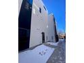 Side exterior view of the home featuring modern design and a black and white color scheme at 1256 Yates St, Denver, CO 80204