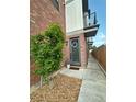 Charming townhome entrance with wreath, stone accent, and a covered walkway at 5423 S Prince St # B, Littleton, CO 80120