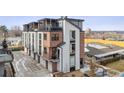 Modern townhome exterior featuring a brick facade and multiple balconies at 5423 S Prince St # B, Littleton, CO 80120