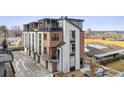 Modern townhome exterior with balconies, brick accents, and sleek architectural design at 5423 S Prince St # B, Littleton, CO 80120